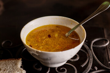 Vegetable soup in a bowl on a dark background.