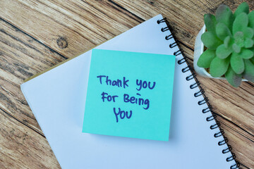 Concept of Thank You For Being You write on sticky notes isolated on Wooden Table.
