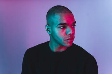 Young African-American man in black sweater looking away - Isolated studio shot. High quality photo