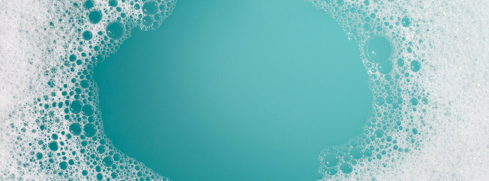 Detergent foam bubble on water. Blue background, Soap sud