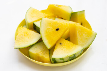 Yellow watermelon slices in plate on white background.