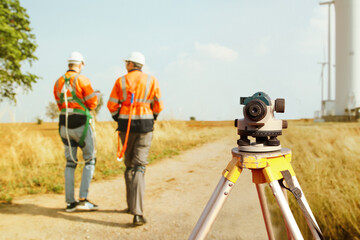 Back view Architect male surveyor team working with surveyor's telescope to measure heights of walk...