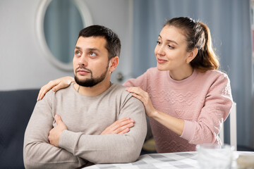 Obraz premium Annoyed frustrated young man ignoring girlfriend asking forgiveness and trying to talk after argument