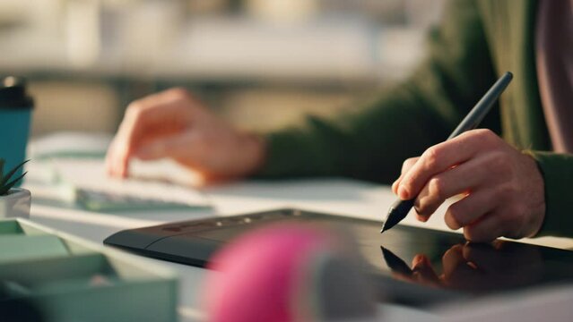 Designer hand drawing stylus digital tablet closeup. Unknown artist creating