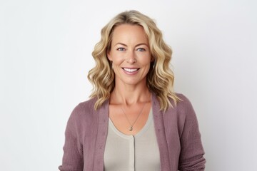 Obraz premium Medium shot portrait photography of a grinning woman in her 40s that is wearing a chic cardigan against a white background . Generative AI
