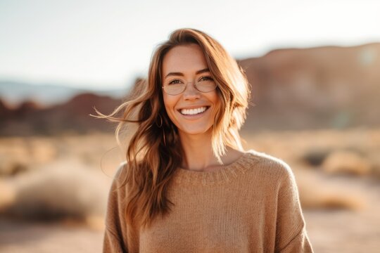 Portrait of a smiling young woman wearing eyeglasses standing outdoors