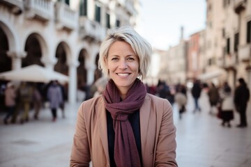 Portrait of smiling middle-aged woman in the street of Venice, Italy
