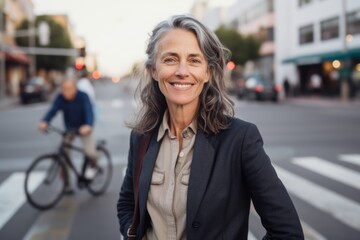 Fototapeta na wymiar Medium shot portrait photography of a pleased woman in her 50s that is wearing a classic blazer against a bustling city intersection with cyclists and pedestrians background . Generative AI