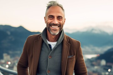 Medium shot portrait photography of a grinning man in his 40s that is wearing a chic cardigan against an aerial view background .  Generative AI