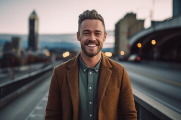 Portrait of a handsome young man smiling outdoors in the city.