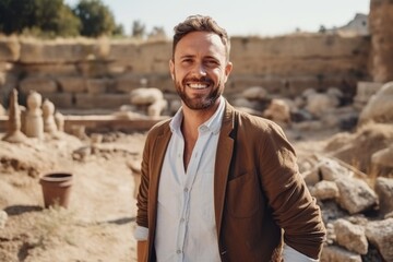 Portrait of a smiling man standing in the ruins of an ancient temple