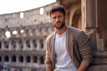 Portrait of a handsome young man in front of Colosseum in Rome, Italy