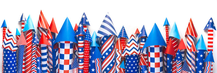 Banner of 4th of July bottle rockets or fireworks in USA colors of red, white, and blue for patriotic US American 4th of July celebration.