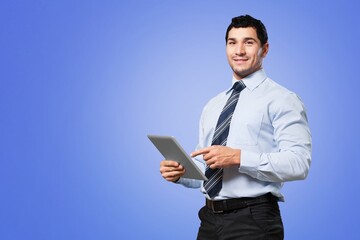 Naklejka na ściany i meble Cheerful young businessman holding digital tablet computer