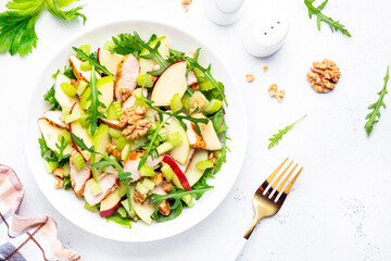 Waldorf salad with chicken fillet, red and green apples, raw celery, lettuce, arugula and walnuts...