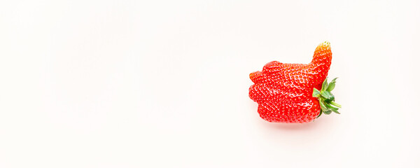 Unusual strawberry in the shape of hand with thumb up similar the like sign, berry background, top...