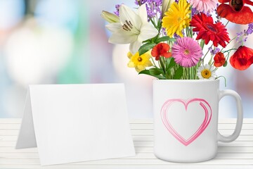 Mug with a pink heart, fresh flowers bouquet