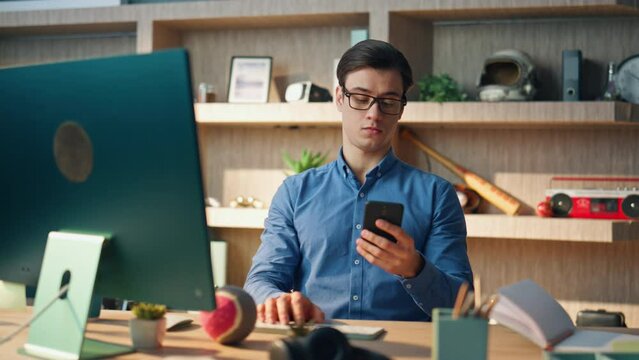 Smiling freelancer answering call at corporate office closeup. Man talking phone