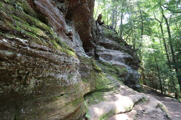 Obraz premium Hiking through the caves, waterfalls, and trees in the woods. 