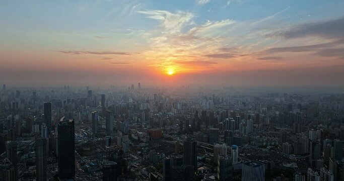 Aerial footage of city skyline and modern buildings in Shanghai at sunset, China. 
