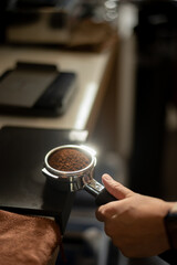 Fototapeta na wymiar Coffee machine with ground coffee in a cafe, close up