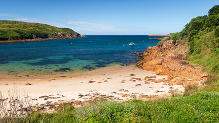 empty beach and boat in blue water on broughton island