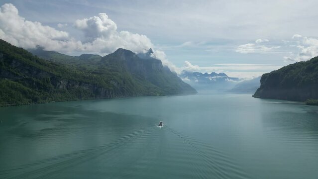 Swiss natural beauty of majestic mountains,serene lake,graceful boat