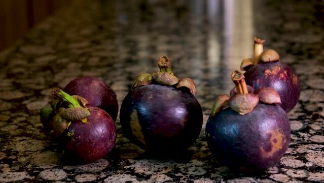 mangosteen on the stone table fresh fruit spinning in one place purple skin color vitamins fresh food