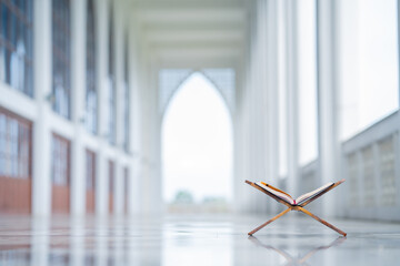 Islamic concept - The Holy Al Quran with written Arabic calligraphy meaning of Al Quran and rosary beads or tasbih, Arabic word translation: The Holy Al Quran (holy book of Muslim) 