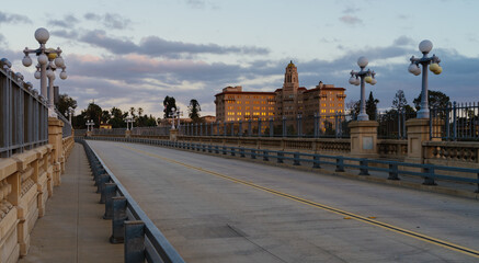 The Colorado Street Bridge and courthouse building shown in the City of Pasadena, California at sunset time.