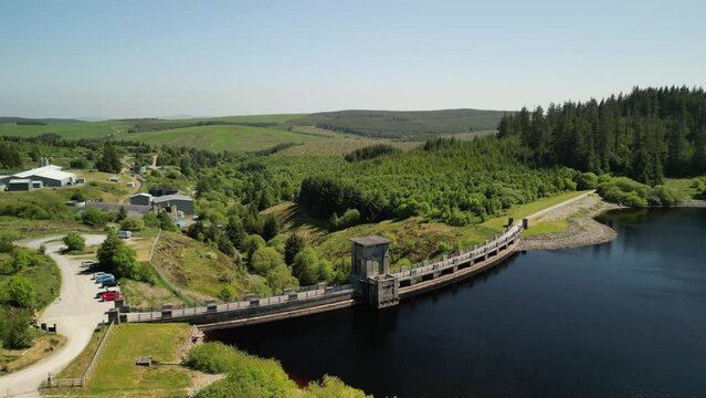 Alwen Reservoir dam Conwy, Wales - Aerial drone medium distance anti-clockwise pan, focus on dam and reveal lake - June 23