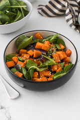  Green salad with sweet potatoes and sesame seeds. Vegan dish. Healthy eating. 