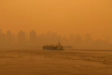 Fotobehang Barge Boat on the East River in New York City with Massive Air Pollution from Wildfires © James