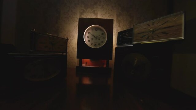 Hyperlapse Shot Of Vintage Clocks Ticking in the Dark. Video Dolly  Moving Backwards and Rotating Shot.