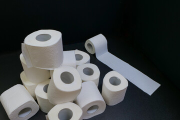 toilet paper rolls on black background