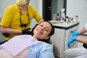 Dental treatment for pregnant women. Gravid female patient smiling with beautiful toothy smile looking at camera, visiting doctor dentist hygienist for check-up during pregnancy in dentistry clinic