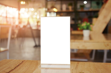 Mock up Menu frame standing on wood table in Bar restaurant cafe. space for text