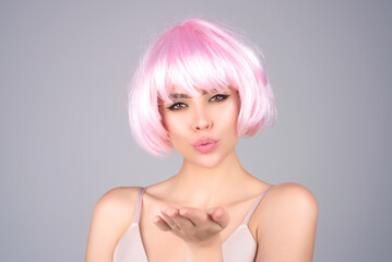 Sensual young woman send air kiss, isolated on studio background. Kiss for you. Sensual woman send air kisses open flirting tempting lips. Affection romantic air kiss on valentines day.