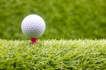 Golf ball is on green grass.