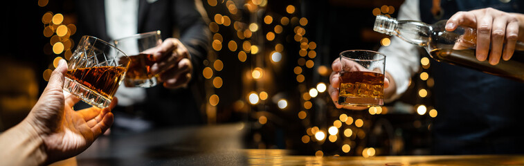  Barman pouring whiskey whiskey glass celebrate whiskey on a friendly party in  restaurant