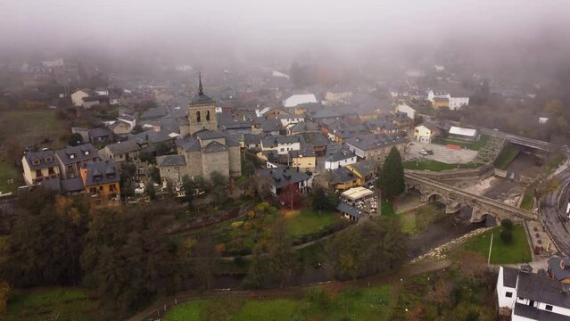 Captivating drone footage of Molinaseca village adorned with a beautiful church