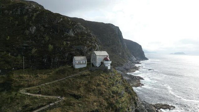 Aerial view of a Lighthouse in M&aring;l&oslash;y on a Moody Day; Hendanes Fyr in Kinn Municipality. Close to M&aring;l&oslash;y, Norway. Aerial panning drone video.