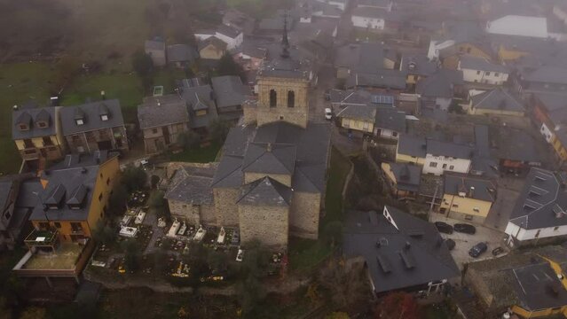 Tranquil drone footage reveals a scenic church surrounded by a cemetery