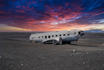 Broken military plane wreck at black sand beach in Solheimasandur at sunset
