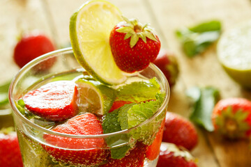 Refreshing drink with strawberry, lime and mint