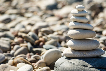 Stack of smooth round stones on pebble beach