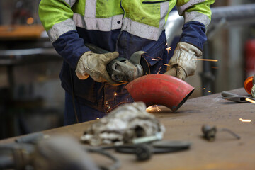 hand welding metal pipe on the factory