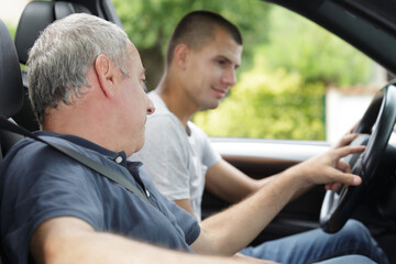 young man having driving lesson