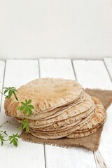 Bread, Egyptian, thin, traditional, on a wooden table, background