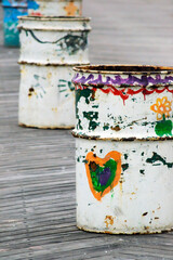 hand painted trash bins on a boardwalk
